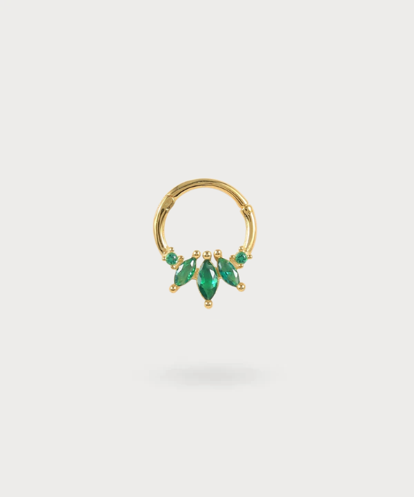 Arrate gold piercing with green stones reminiscent of emeralds